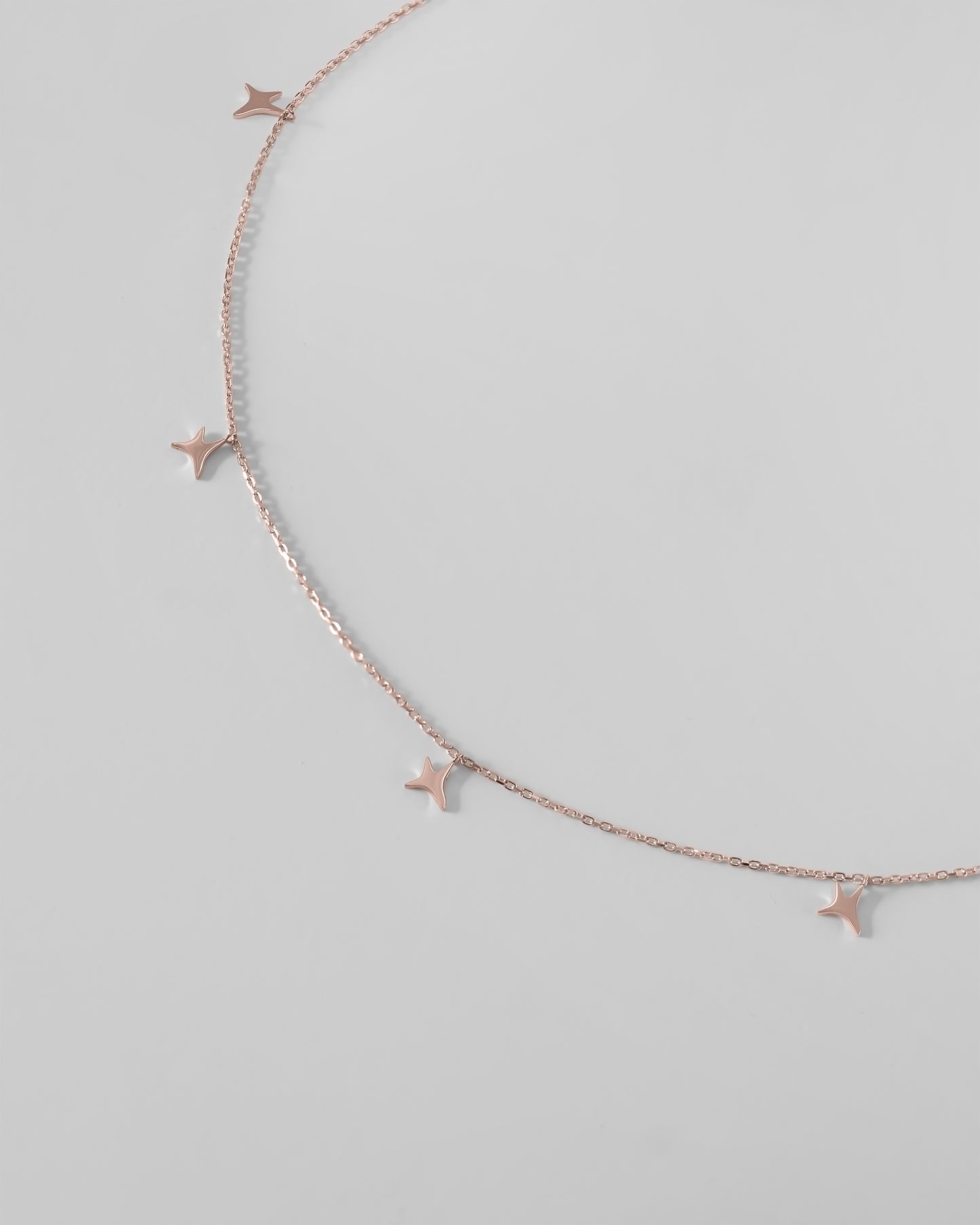 Rose gold AUMI stars necklace